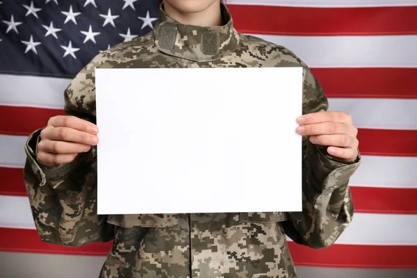 Female soldier with blank poster on flag background, closeup — Stock Photo, Image