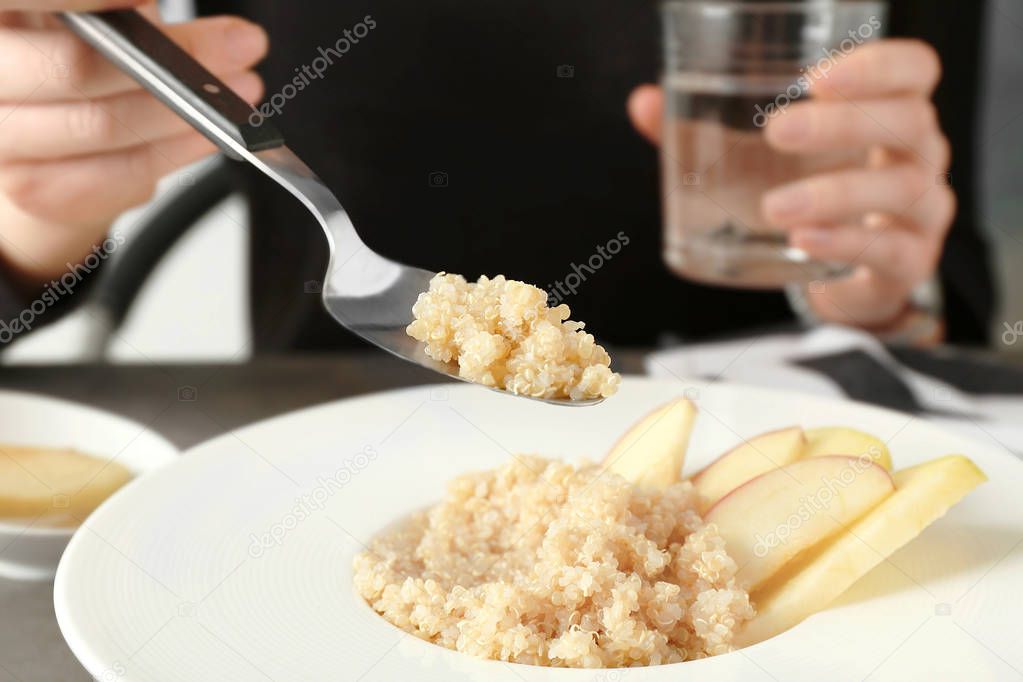 Woman eating quinoa porridge 