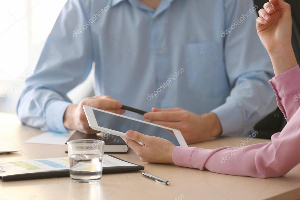 Young managers with tablet computer 