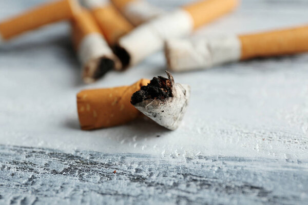 Cigarette butts on wooden