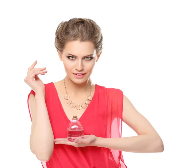 Beautiful young woman with bottle of perfume — Stock Photo, Image