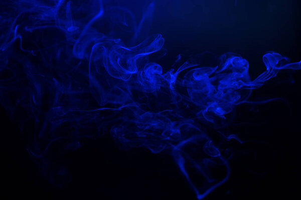 Swirl of blue smoke on black background