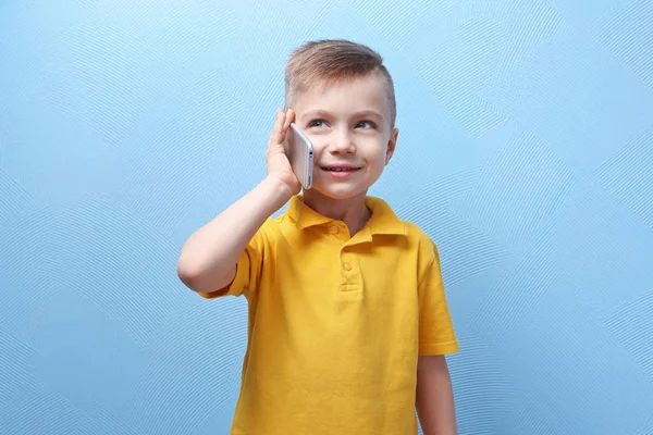 Cute little boy talking by phone — Stock Photo, Image