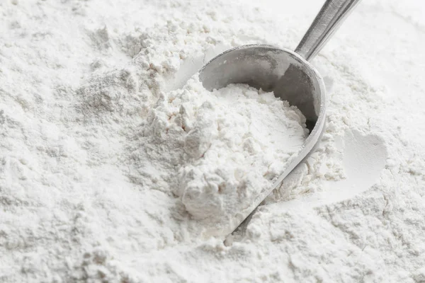 Metal scoop in flour — Stock Photo, Image