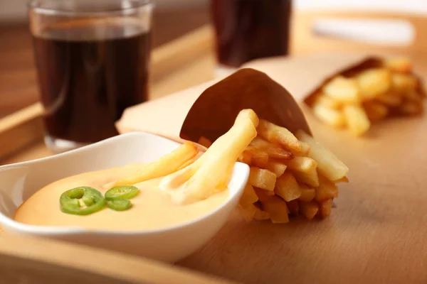 Tasty fries in cheese sauce — Stock Photo, Image