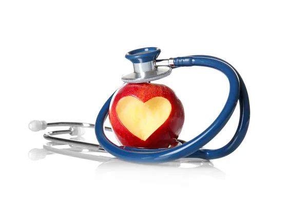 Apple with heart-shaped cut and stethoscope — Stock Photo, Image