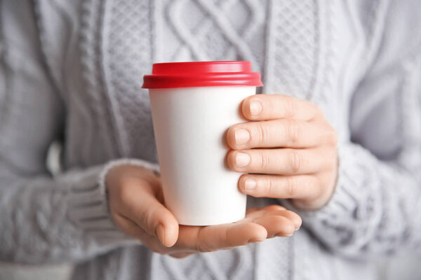 Woman holding paper cup