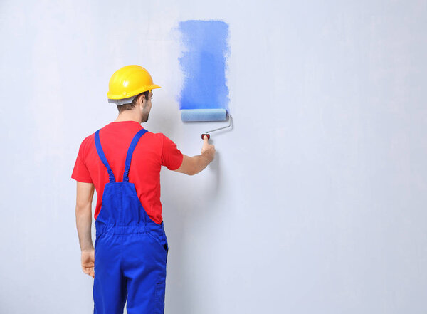 worker painting wall 