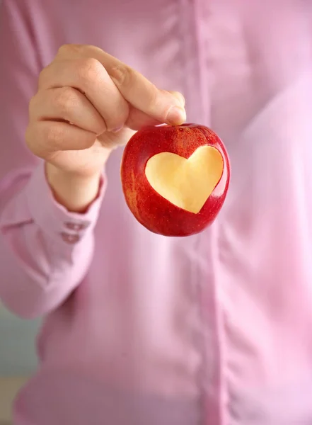 Apple with heart-shaped cut out — Stock Photo, Image