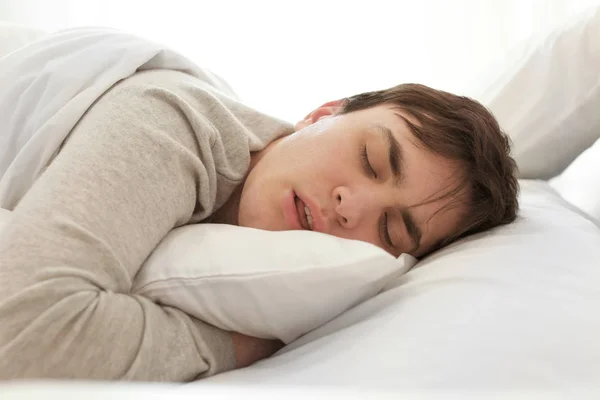 Man sleeping in bed Stock Image