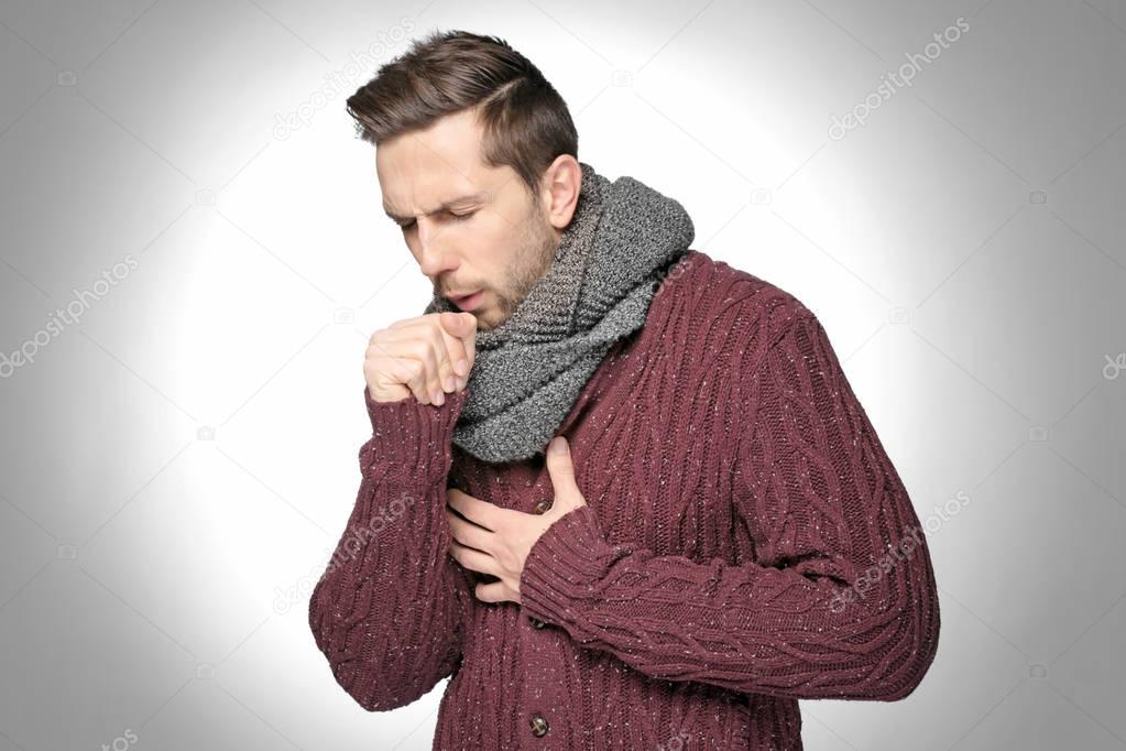 Young man coughing 