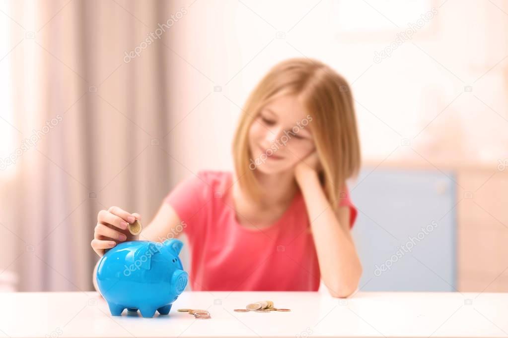 Cute girl with piggy bank