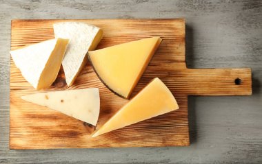 Board with delicious cheese   clipart
