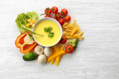 creamy cheese in bowl and fresh vegetables clipart
