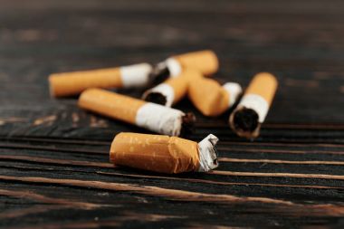 Cigarette butts on wooden clipart