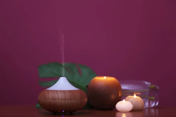 Aroma oil diffuser and candles — Stock Photo, Image