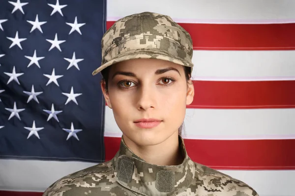 Portrait of female soldier with USA flag on background — Stock Photo, Image