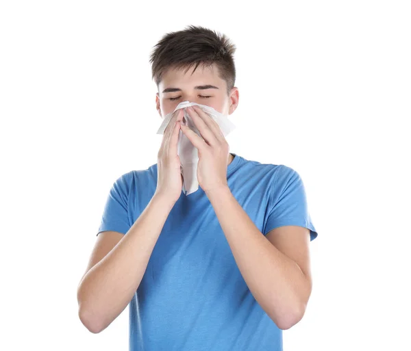 Young man blowing nose in tissue — Stock Photo, Image