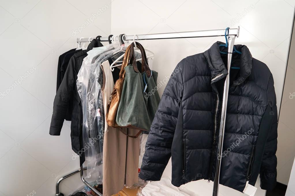 Clothes and bags on metallic rack