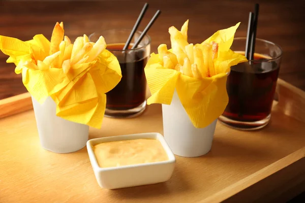 Tasty fries, cheese sauce on tray — Stock Photo, Image