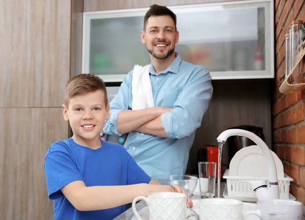 Apa és fia, csinál a mosógép konyha — Stock Fotó