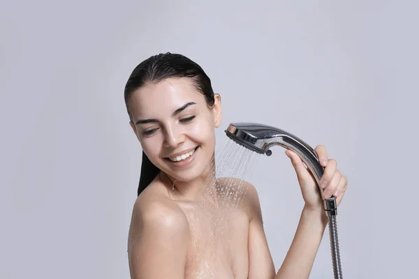 Genç kadın duş başlığı ile — Stok fotoğraf