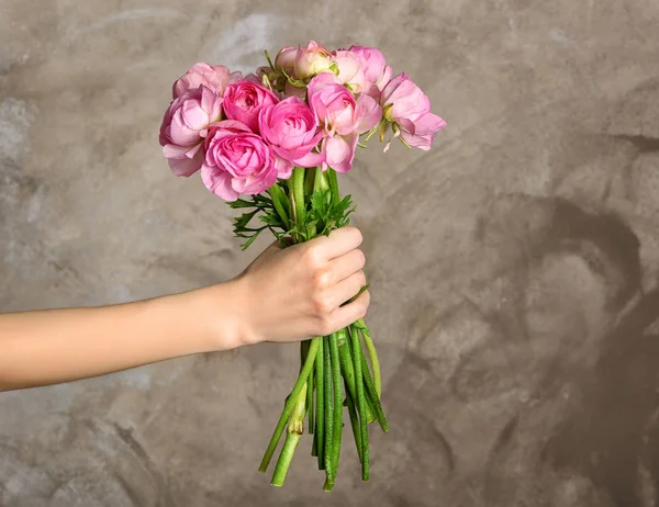 Female hand holding bouquet of flowers — Stock Photo, Image