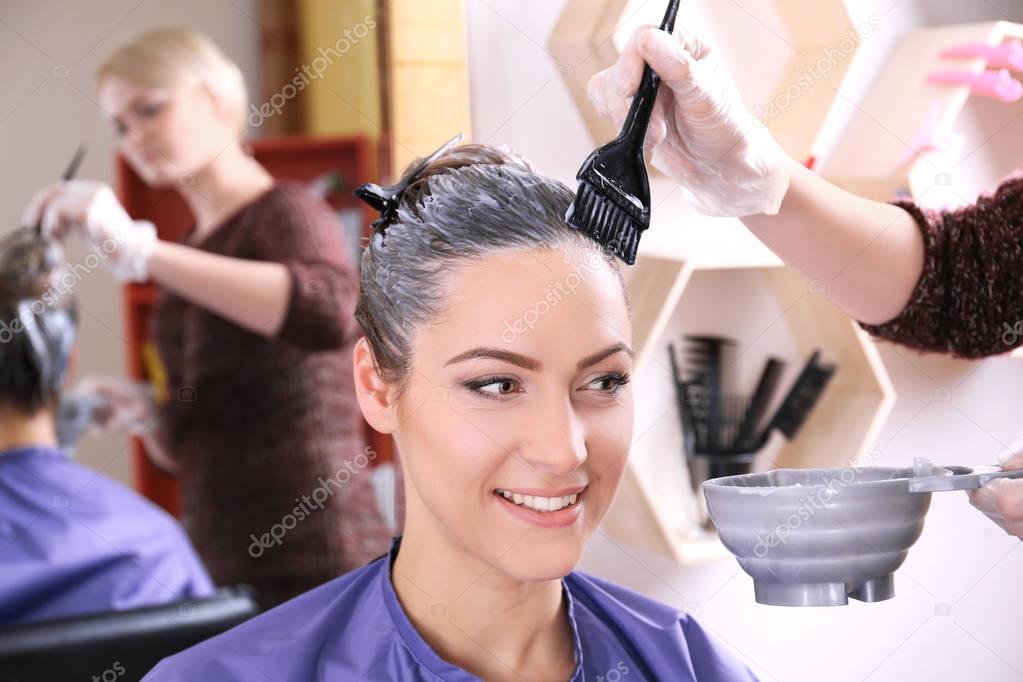 Young woman dyeing hair 