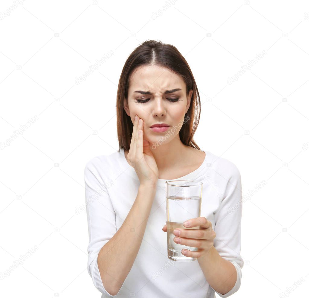 Beautiful young woman with medicine  suffering from toothache on white background