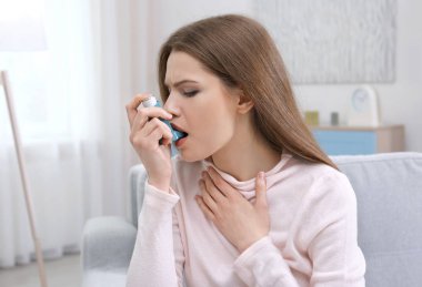woman using asthma inhaler  clipart
