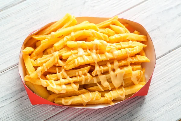 delicious french fries with cheese sauce