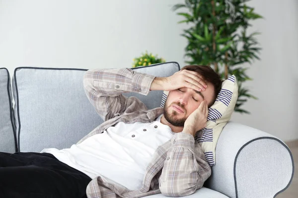 Giovane uomo che soffre di mal di testa a casa — Foto Stock