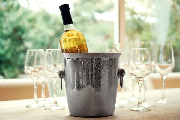 Wine bottle in bucket with ice — Stock Photo, Image