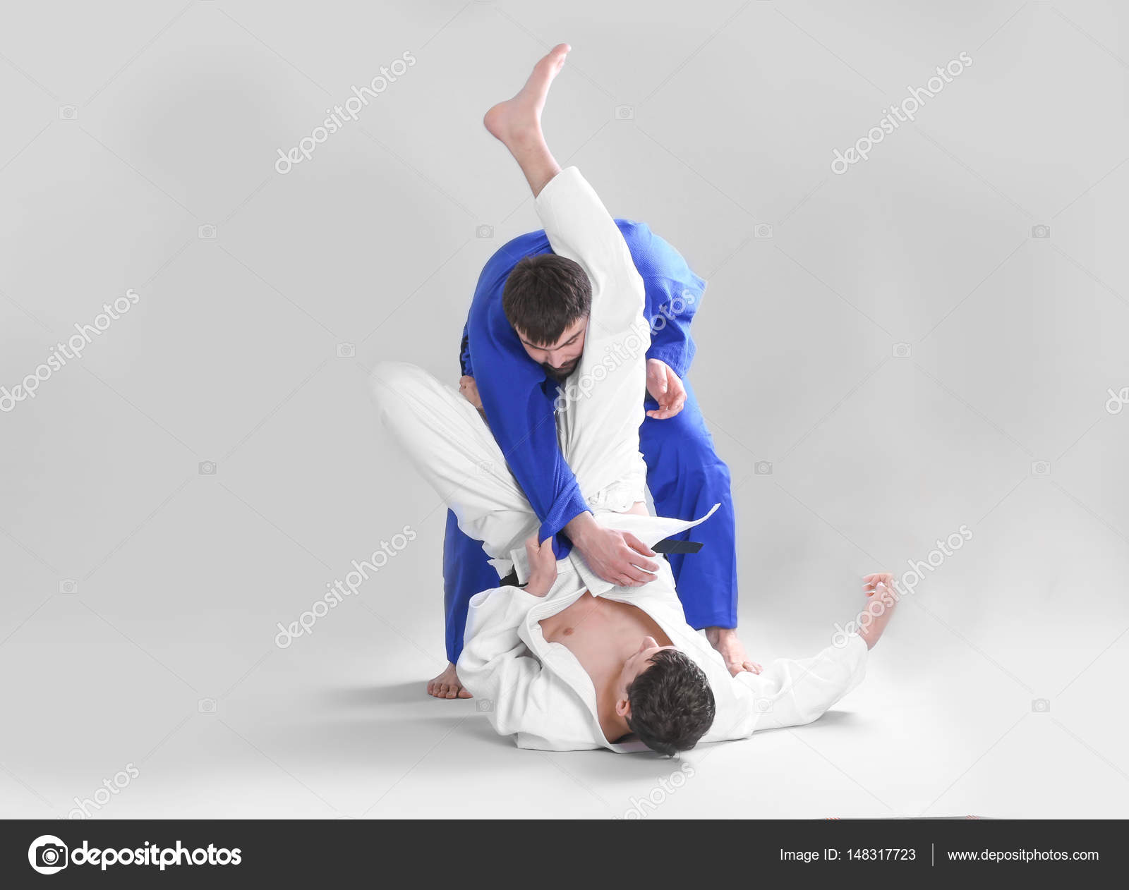 Men practicing martial arts Stock Photo by ©belchonock 148317723