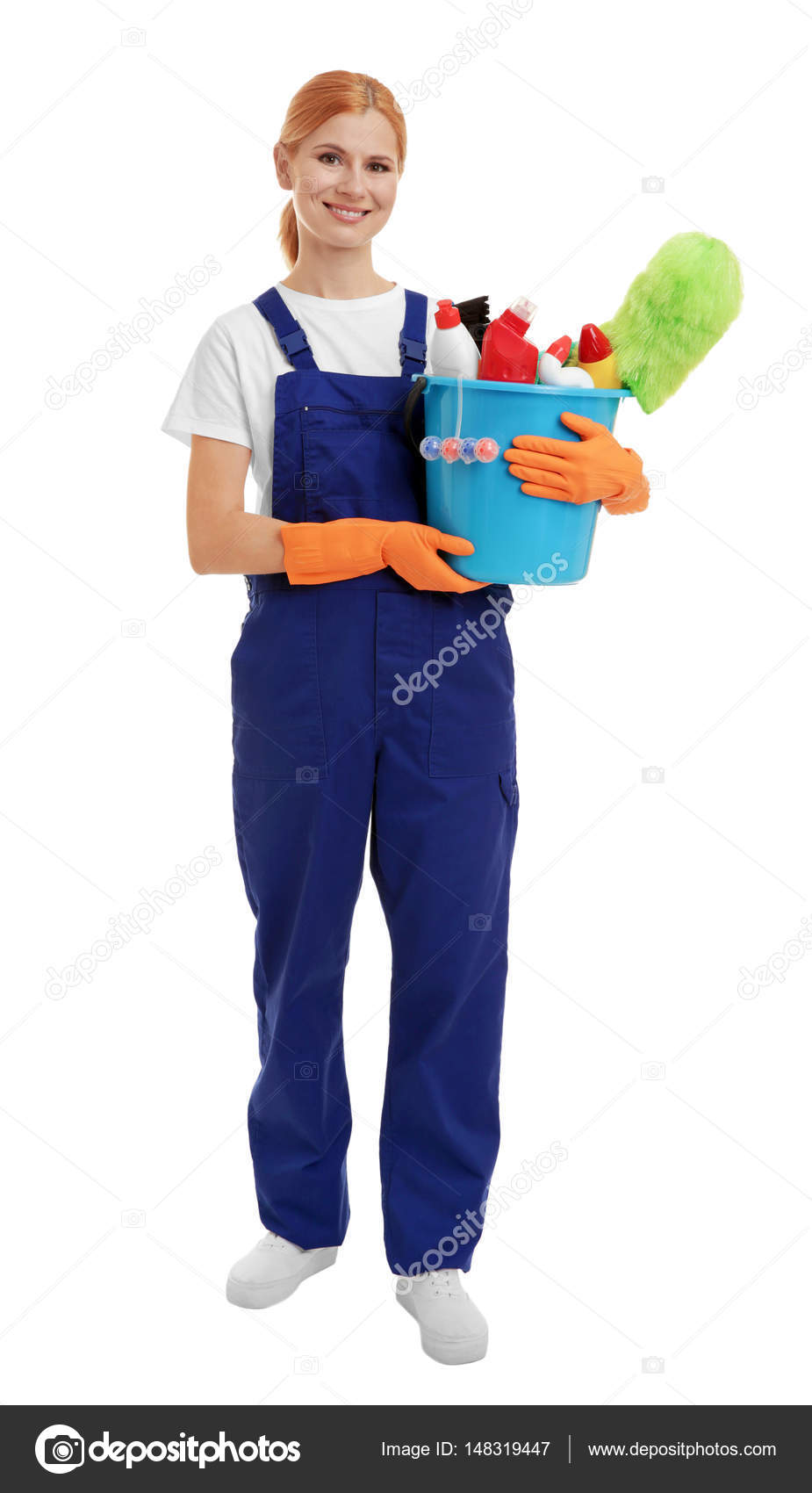 Woman holding bucket with cleaning agents and supplies on white