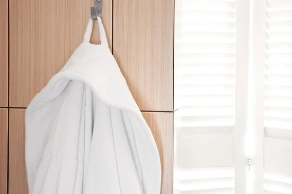 Bathrobe hanging on hook — Stock Photo, Image