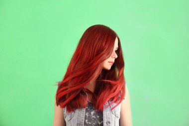 Beautiful young woman with dyed hair on color background clipart