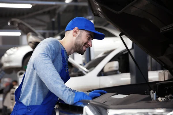 Junger Mechaniker mit blauer Mütze — Stockfoto