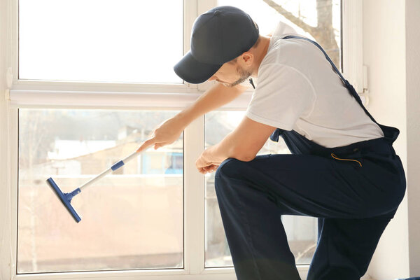 man washing window