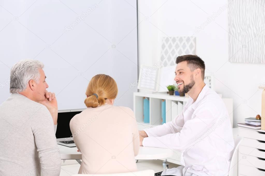 couple discussing terms of insurance contract 