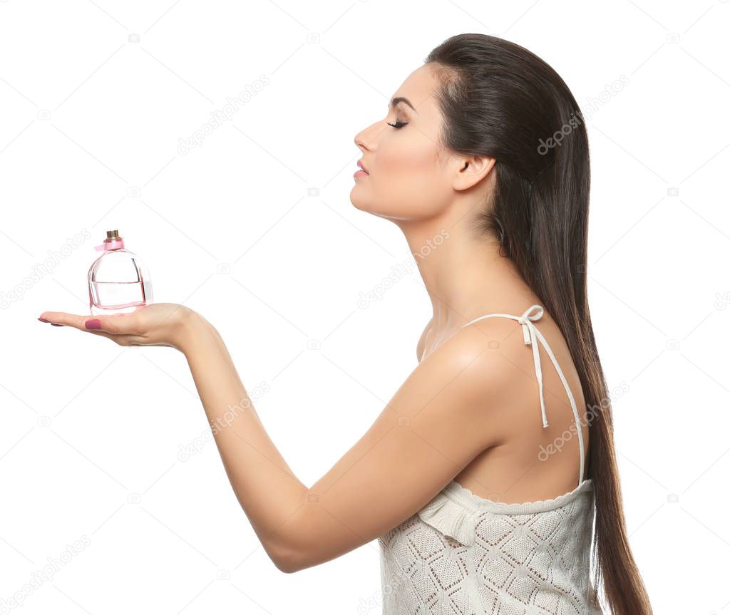 Beautiful young woman with bottle of perfume 