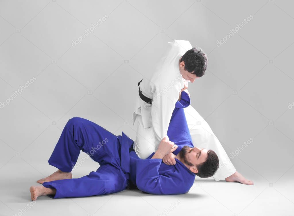 Men practicing martial arts