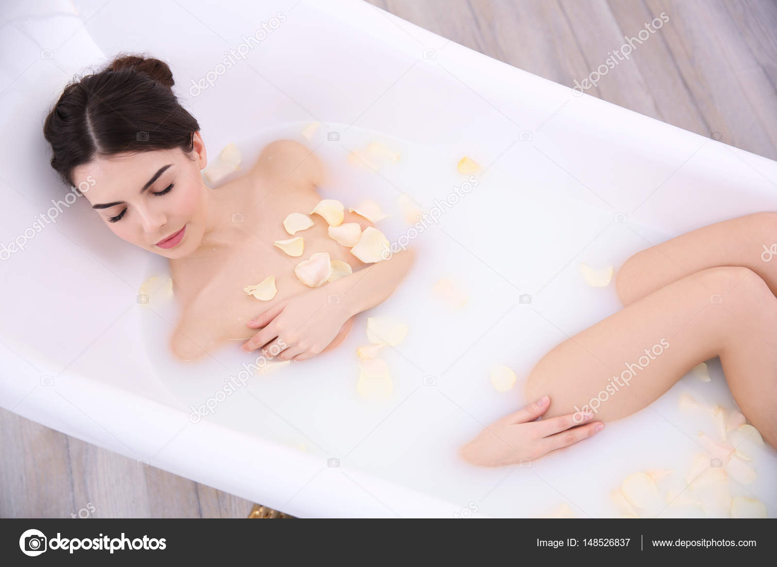 Young woman taking bath Stock Photo by ©belchonock 148526837
