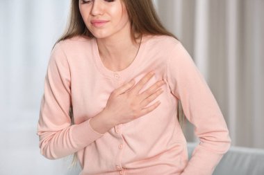 Girl having a heart attack at home clipart