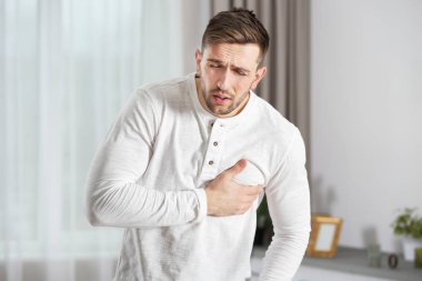 Man having a heart attack at home clipart