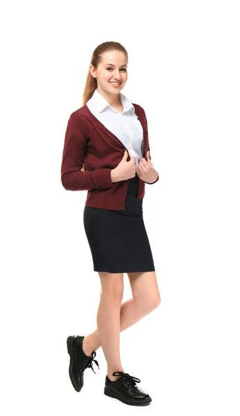 Mooie schoolmeisje in uniforme staande op lichte achtergrond — Stockfoto