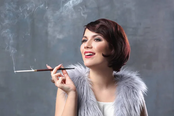 Woman smoking with cigarette holder — Stock Photo, Image