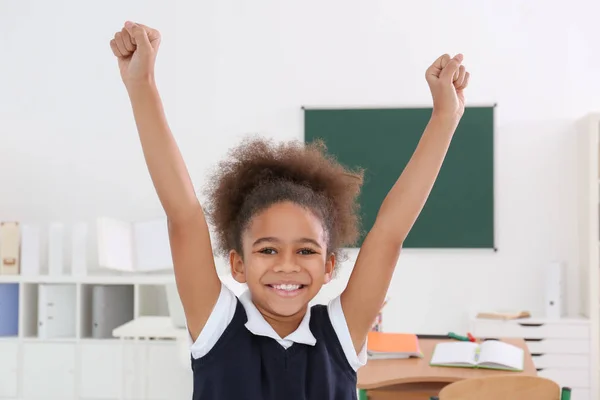 Portrait of cute African-American girl in classroom — Stock Photo, Image
