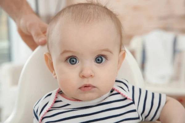 Adorable baby girl sitting in chair for babies — Stock Photo, Image