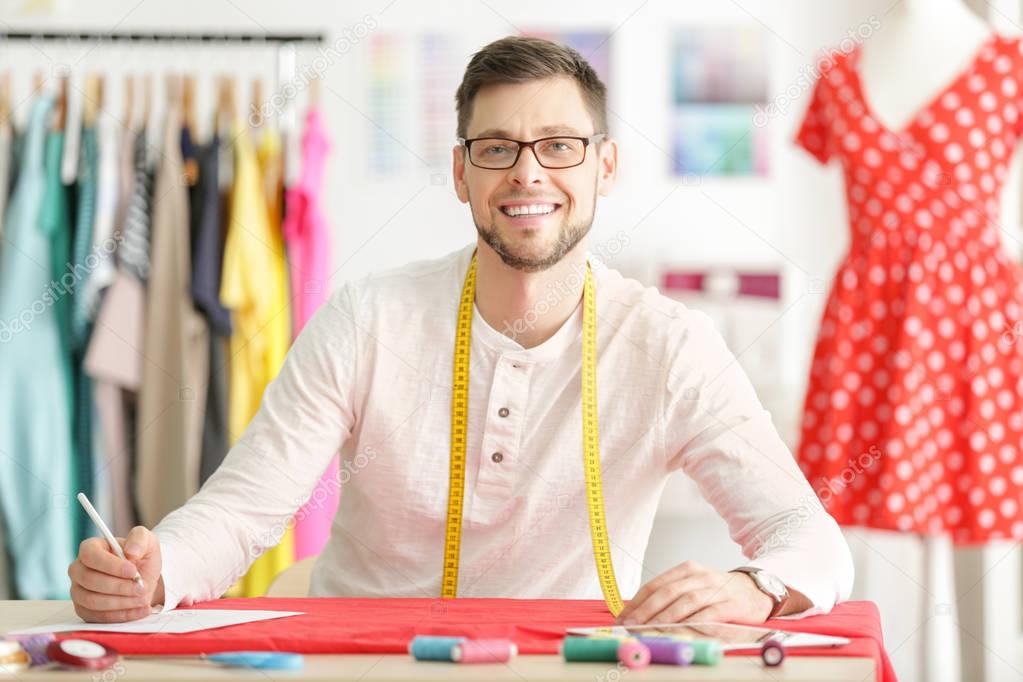 Young male fashion designer at workplace